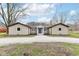 Charming single-story home with a gravel driveway and inviting blue front door at 2420 Goose Creek Rd, Martinsville, IN 46151