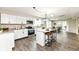 Bright kitchen features white cabinets, granite counters, stainless appliances, and a large center island with seating at 2420 Goose Creek Rd, Martinsville, IN 46151
