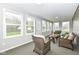 Bright sunroom with lots of windows, comfortable wicker seating and a view of the backyard at 2420 Goose Creek Rd, Martinsville, IN 46151