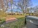 Spacious backyard with mature trees, brick patio, and plenty of room for outdoor activities at 2429 N Arsenal Ave, Indianapolis, IN 46218
