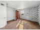 Bedroom showcasing a window, closet, and geometric accent wall at 2429 N Arsenal Ave, Indianapolis, IN 46218