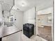 Compact kitchen equipped with a gas range, vintage cabinets, and a view into the adjoining living room at 2429 N Arsenal Ave, Indianapolis, IN 46218