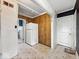 View of the kitchen with retro wood panels and tile floors and a white refrigerator at 2429 N Arsenal Ave, Indianapolis, IN 46218