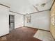 Spacious living room with brown carpet and a view into the kitchen area at 2429 N Arsenal Ave, Indianapolis, IN 46218