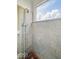 Close up of the tiled shower stall and shower head at 2429 N Arsenal Ave, Indianapolis, IN 46218