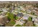 A quaint home is surrounded by trees in this aerial view showing the street and neighborhood at 310 W Staat St, Fortville, IN 46040