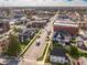 Aerial view of the town showcasing houses, businesses, and the water tower in the background at 310 W Staat St, Fortville, IN 46040