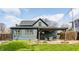 The backyard features a cozy covered patio with comfortable seating and landscaping at 310 W Staat St, Fortville, IN 46040