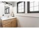 Updated bathroom with modern vanity, mirror, lighting, and large window for natural light at 310 W Staat St, Fortville, IN 46040