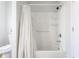 Modern bathroom featuring a bathtub with white shower, a toilet, and a shower curtain at 310 W Staat St, Fortville, IN 46040