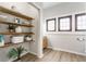 Bright bathroom with wood shelves, three windows, and warm-toned wooden floors at 310 W Staat St, Fortville, IN 46040