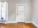 Bright entryway with hardwood floors, white trim, and a charming front door with a window at 310 W Staat St, Fortville, IN 46040