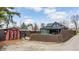 Side view of the home showcasing the fenced yard, storage shed, and well-maintained exterior at 310 W Staat St, Fortville, IN 46040