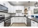 Functional kitchen with stainless steel appliances, white cabinets and dark countertops at 310 W Staat St, Fortville, IN 46040