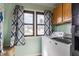 Well-equipped laundry room featuring a washing machine, dryer, window, and storage cabinets at 310 W Staat St, Fortville, IN 46040