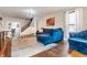 Inviting living room featuring hardwood floors and a blue sectional sofa at 310 W Staat St, Fortville, IN 46040