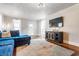 Cozy living room with hardwood floors, a stylish rug, and a comfortable blue sectional couch at 310 W Staat St, Fortville, IN 46040