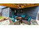 Charming covered patio with a fire pit table and comfortable seating, perfect for outdoor enjoyment at 310 W Staat St, Fortville, IN 46040