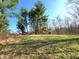 Green backyard with mature trees, ideal for outdoor activities and relaxation at 3395 State Road 44, Martinsville, IN 46151