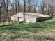 Side view of a barn with a metal roof, featuring a fenced-in pasture and grassy field at 3395 State Road 44, Martinsville, IN 46151