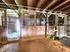 Inside the barn, featuring multiple stalls, an open door, and wooden construction at 3395 State Road 44, Martinsville, IN 46151