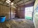 Inside the wooden barn stall, showcasing the dirt floor and wood-paneled walls at 3395 State Road 44, Martinsville, IN 46151