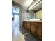 Bathroom showcases a wooden vanity with a wide mirror and traditional fixtures at 3395 State Road 44, Martinsville, IN 46151