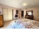 Bedroom with floral bedding, double mirrored closet doors, and neutral carpet at 3395 State Road 44, Martinsville, IN 46151