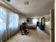 Spacious bedroom with rocking chair and large window providing natural light at 3395 State Road 44, Martinsville, IN 46151