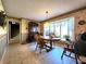 Cozy dining room with a view of the yard through a bay window and classic furniture at 3395 State Road 44, Martinsville, IN 46151
