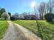 Charming home with well-maintained landscaping, mature trees, and long gravel driveway at 3395 State Road 44, Martinsville, IN 46151