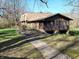 Unique home featuring stone accents, screened-in porch, and mature landscaping at 3395 State Road 44, Martinsville, IN 46151