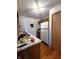 Compact kitchen featuring a classic white refrigerator and traditional wooden cabinetry at 3395 State Road 44, Martinsville, IN 46151