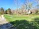 Property view showing a dirt road, fenced pasture, and a white outbuilding at 3395 State Road 44, Martinsville, IN 46151