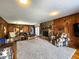 Relaxing living room featuring wood paneling, a stone fireplace, and plush seating at 3395 State Road 44, Martinsville, IN 46151