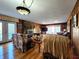Cozy living room with wood paneled walls, stone fireplace, and plush floral sofas at 3395 State Road 44, Martinsville, IN 46151