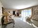 Spacious living room featuring patterned wallpaper, neutral carpet, and large windows at 3395 State Road 44, Martinsville, IN 46151