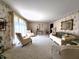 Bright living room with patterned wallpaper, neutral carpet, and large windows at 3395 State Road 44, Martinsville, IN 46151