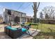 Inviting backyard with a trampoline, patio seating, and ample space for recreation and relaxation at 3636 N Chester Ave, Indianapolis, IN 46218