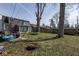 Spacious backyard featuring a trampoline, fire pit, patio seating, and mature trees at 3636 N Chester Ave, Indianapolis, IN 46218