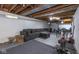 This basement has exposed unfinished ceiling, painted walls, large gray couch, and a peloton at 3636 N Chester Ave, Indianapolis, IN 46218