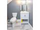 This bathroom features a white vanity with a sink, a mirror, and a white toilet at 3636 N Chester Ave, Indianapolis, IN 46218
