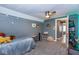Gray bedroom with ceiling fan and dinosaur wall decor, and partially furnished with a bed at 3636 N Chester Ave, Indianapolis, IN 46218
