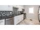 Well-maintained kitchen with modern appliances, stylish backsplash, granite counters and white cabinets at 3636 N Chester Ave, Indianapolis, IN 46218