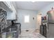 Galley-style kitchen featuring stainless steel appliances, patterned backsplash, and bright lighting at 3636 N Chester Ave, Indianapolis, IN 46218