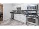 Modern kitchen with stainless steel appliances, sleek countertops, and stylish backsplash and tile floors at 3636 N Chester Ave, Indianapolis, IN 46218