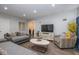 Inviting living room featuring a modern TV and cabinet, with stylish decor and wood flooring at 3636 N Chester Ave, Indianapolis, IN 46218