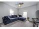 Comfortable living room featuring a spacious blue sofa, neutral carpet, and bright natural light at 3636 N Chester Ave, Indianapolis, IN 46218