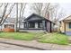 Well-maintained home features a classic design and neat front lawn at 3704 Graceland Ave, Indianapolis, IN 46208