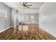 Spacious living area with hardwood floors, a fireplace, and a ceiling fan at 3704 Graceland Ave, Indianapolis, IN 46208